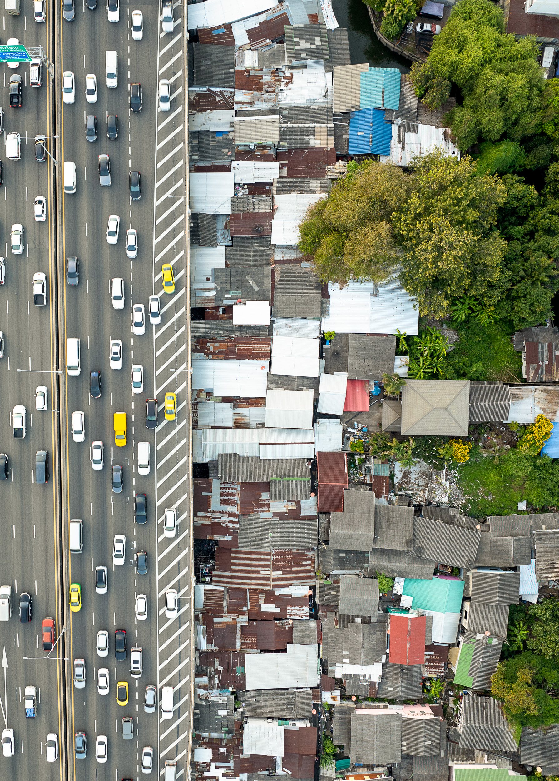 The traffic, waterways, and densely packed architecture are paradigmatic of the city, and of the inequalities and challenges that shape its