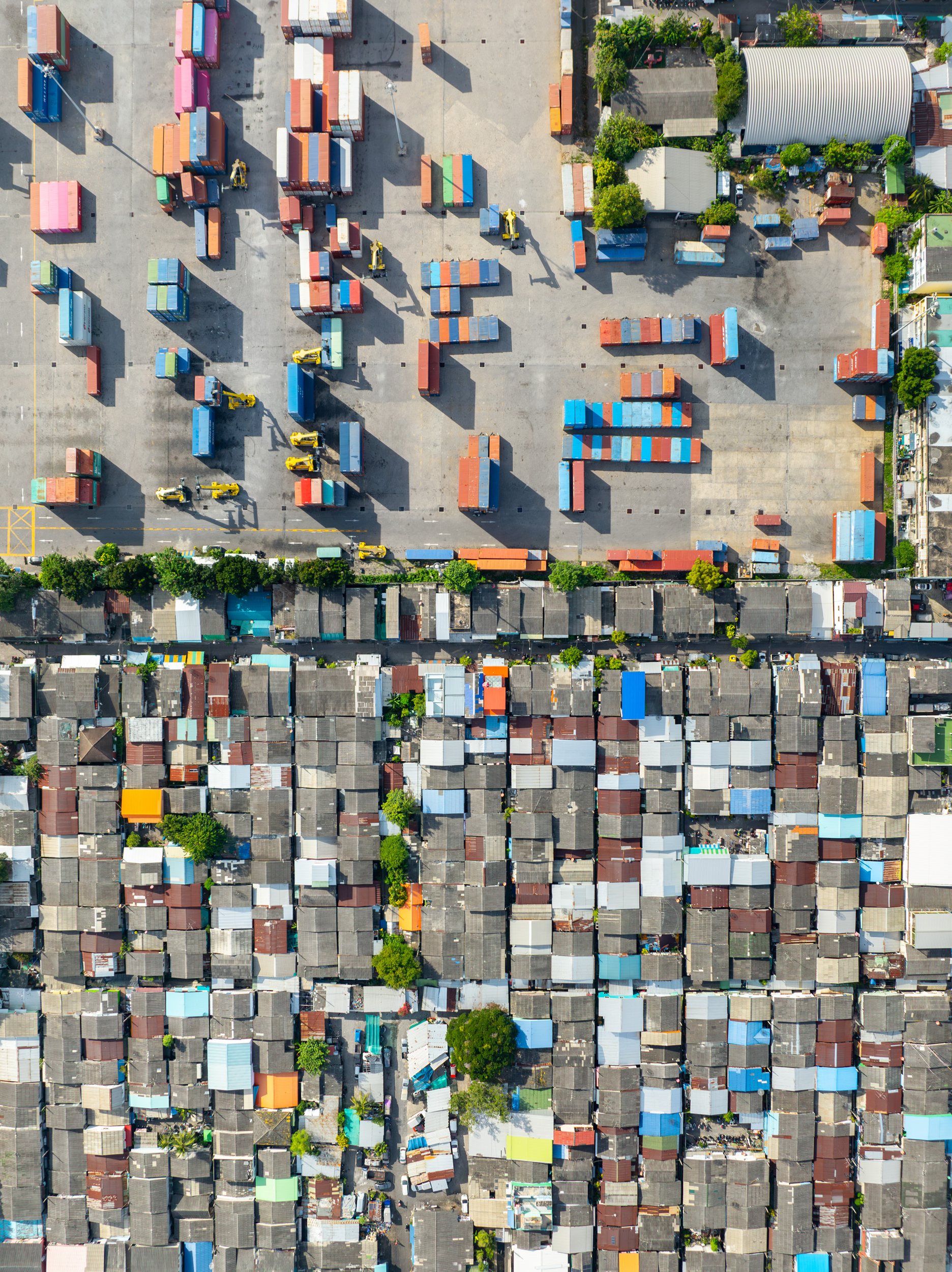 Densely packed communities next to the Port of Bangkok, alongside the Chao Praya river.