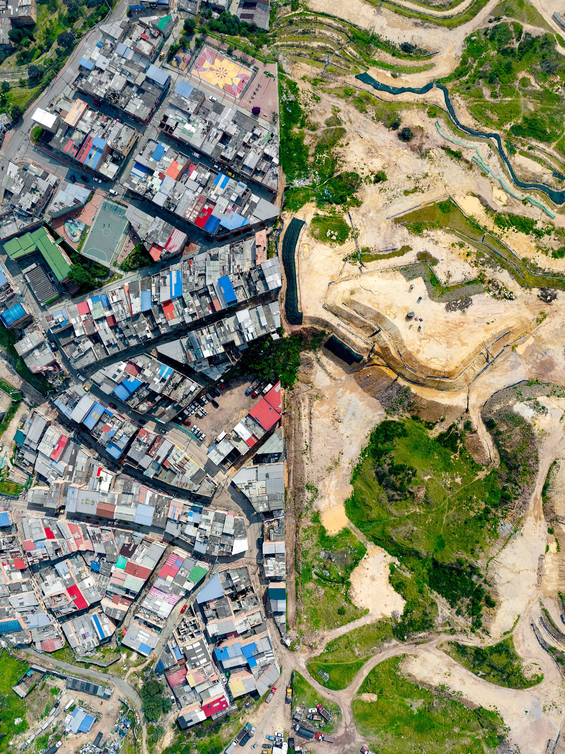 New construction climbs the hillside in El Consuelo, a working-class barrio on the cerros orientales, the steep eastern range that rises