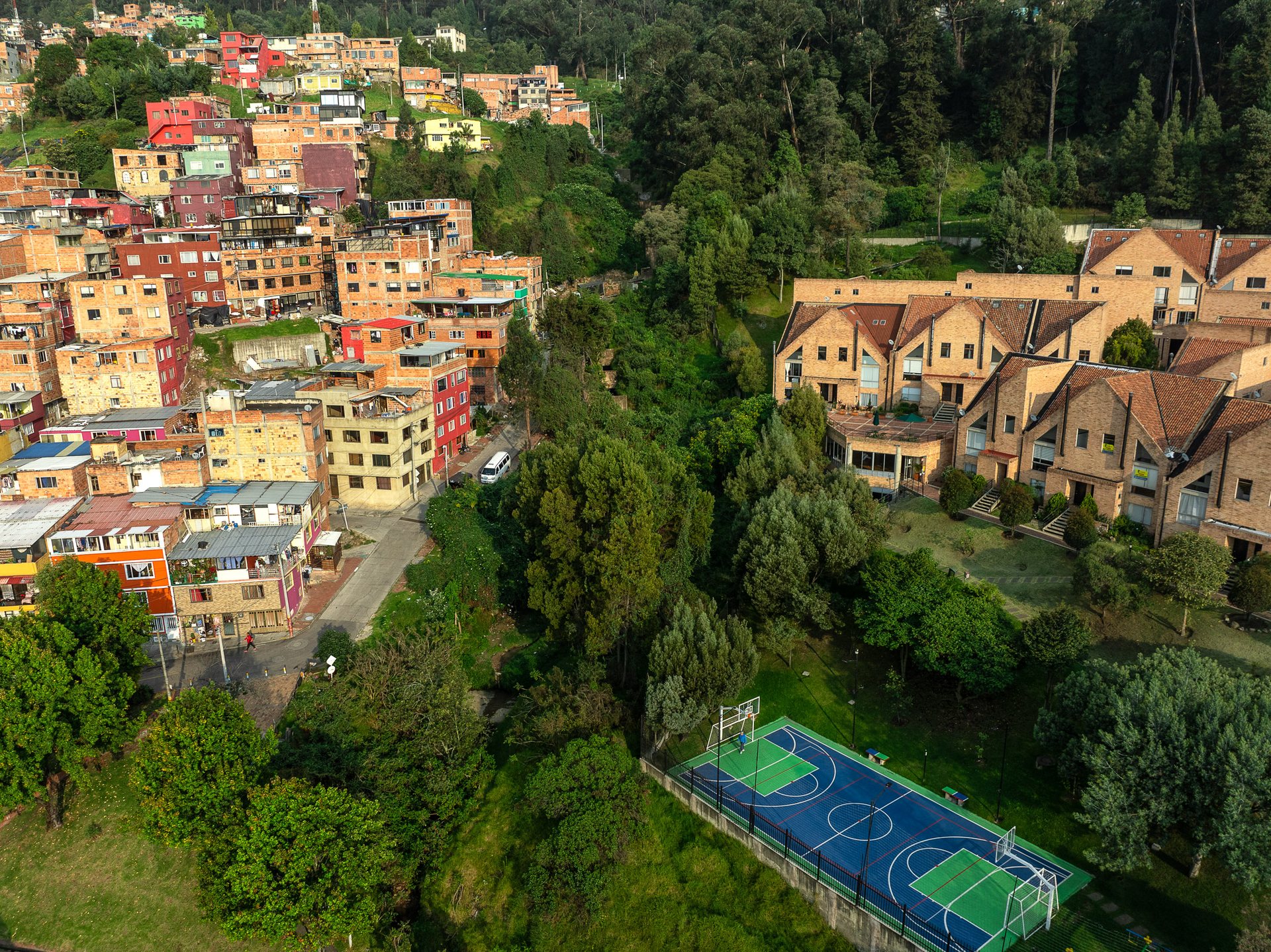 Different strata households exist side by side in the foothills of the Andes, where informal housing took off after decades of migration