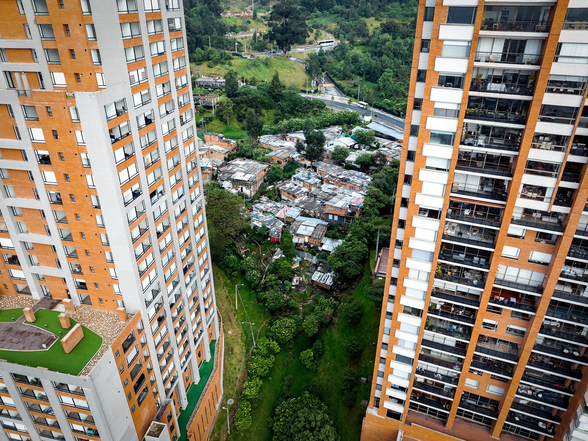 In Chapinero, informal housing is sandwiched between expensive new development in one of Bogotá's nicest districts, and the steep mountains