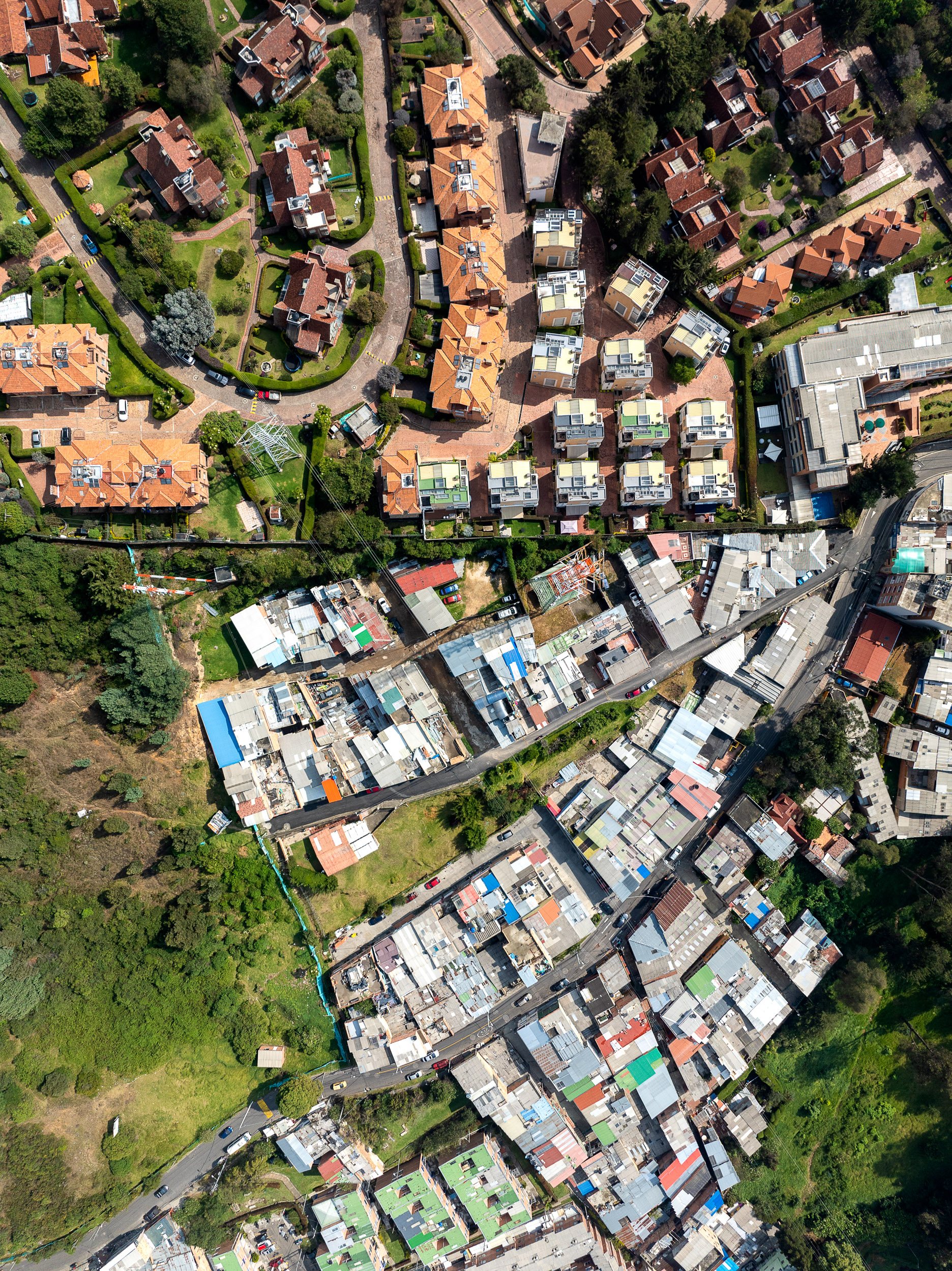 The neat line of a fence separates poor and rich in the Suba Hills.