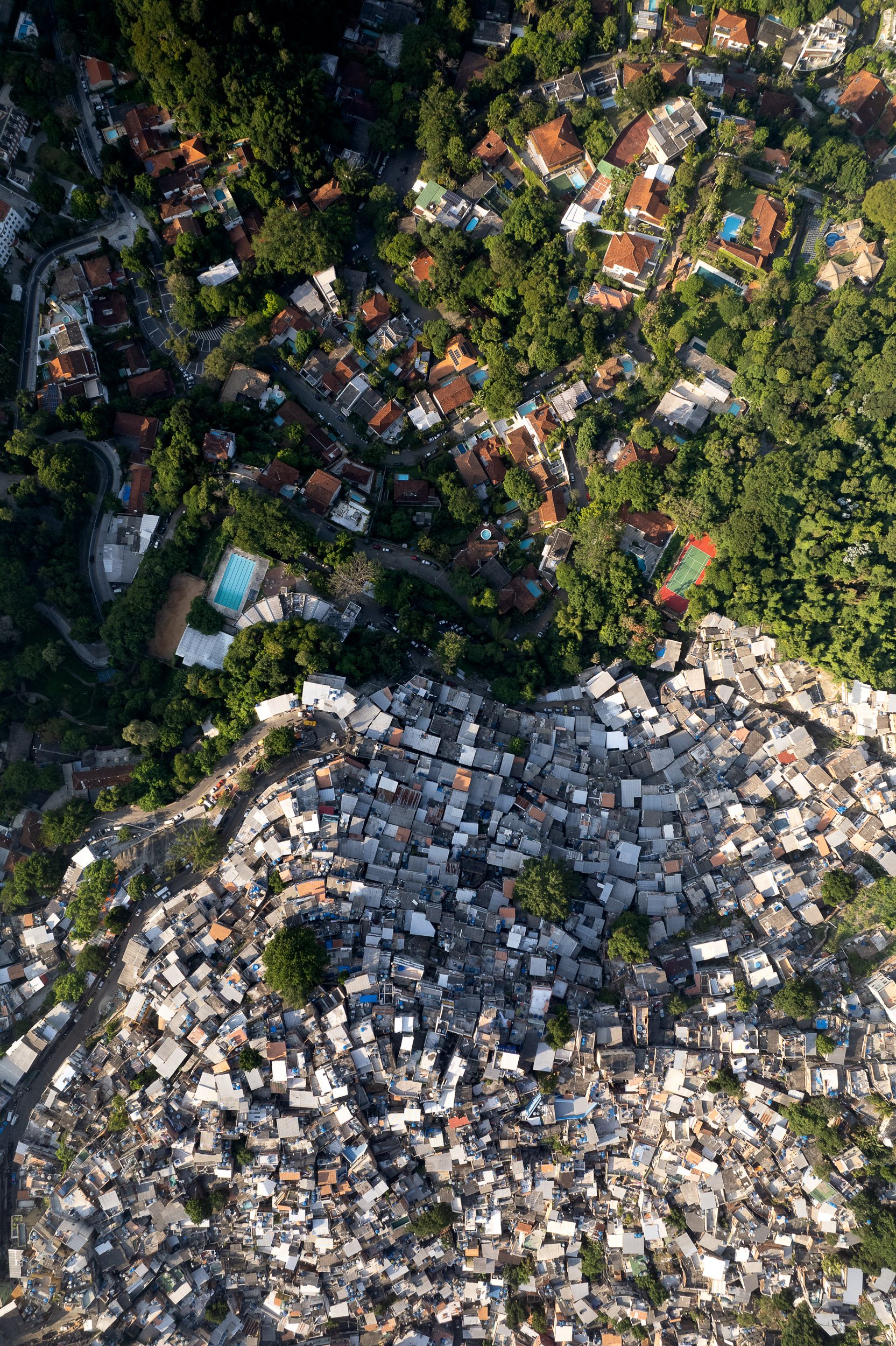 Rocinha favela in Rio, densely packed against green hillside homes.