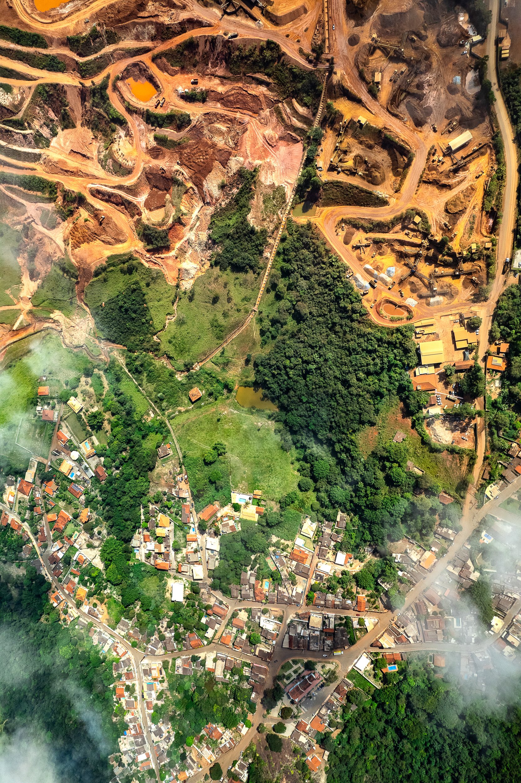 Aerial photograph of Tejuco, Brazil, where houses lie in close proximity to gold mines after environmental disaster