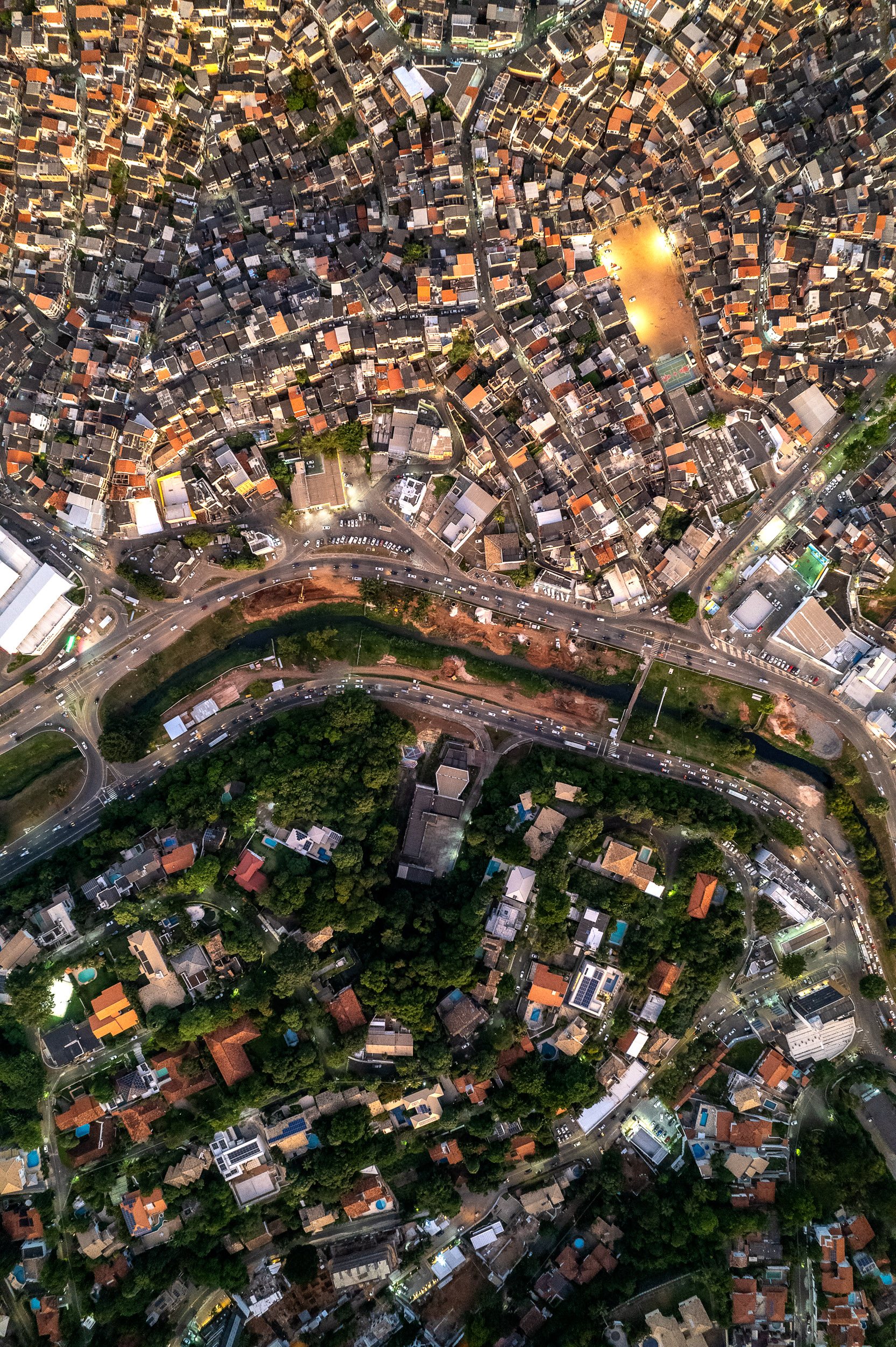 Across Avenida Juracy Magalhães Júnior in Salvador, the line is clear at dusk: the dense, self-built homes of the Nordeste de Amaralina