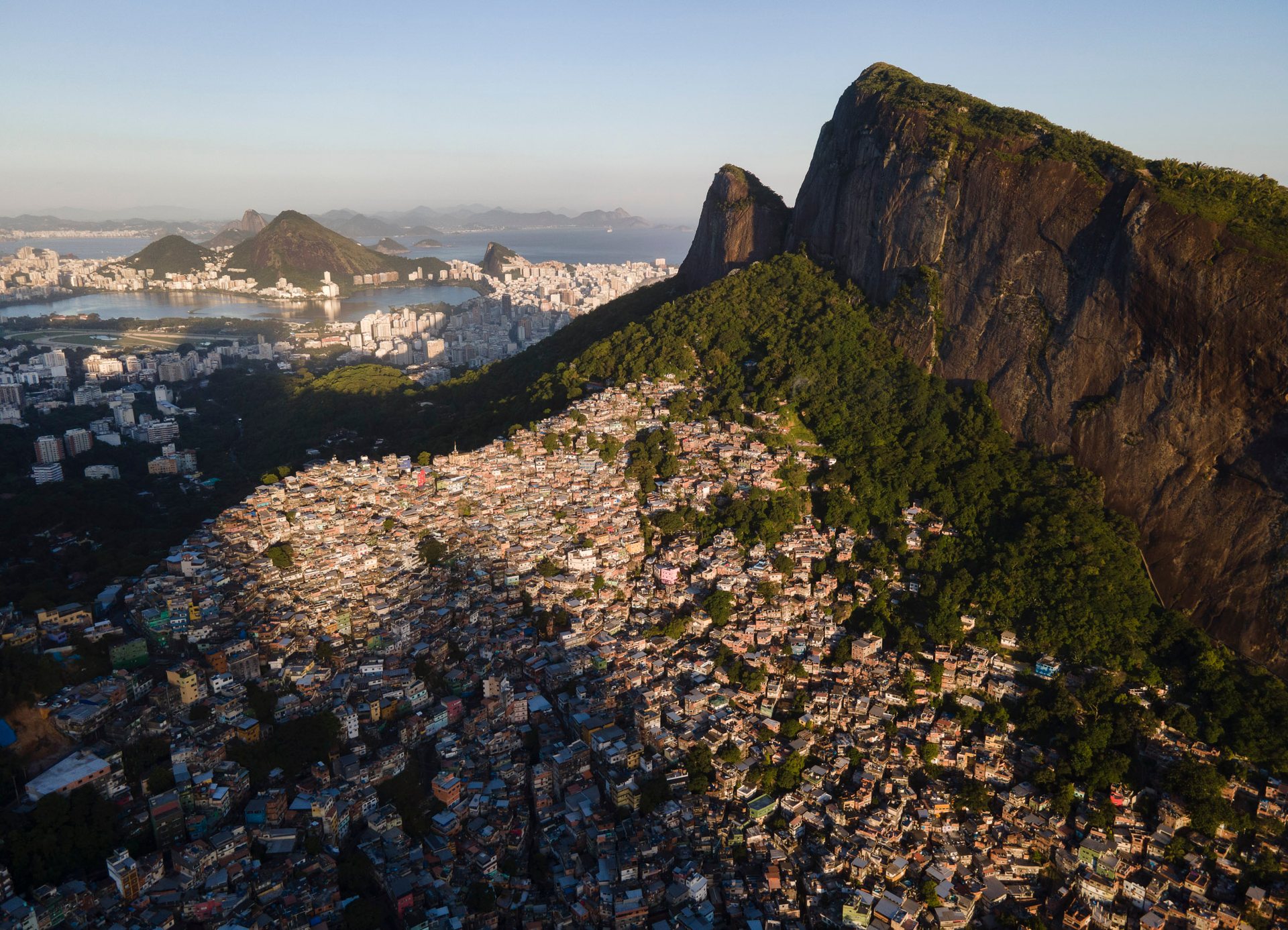 Rocinha, one of Latin America's largest favelas, sprawling up a steep mountainside with Rio’s affluent South Zone in the distance.