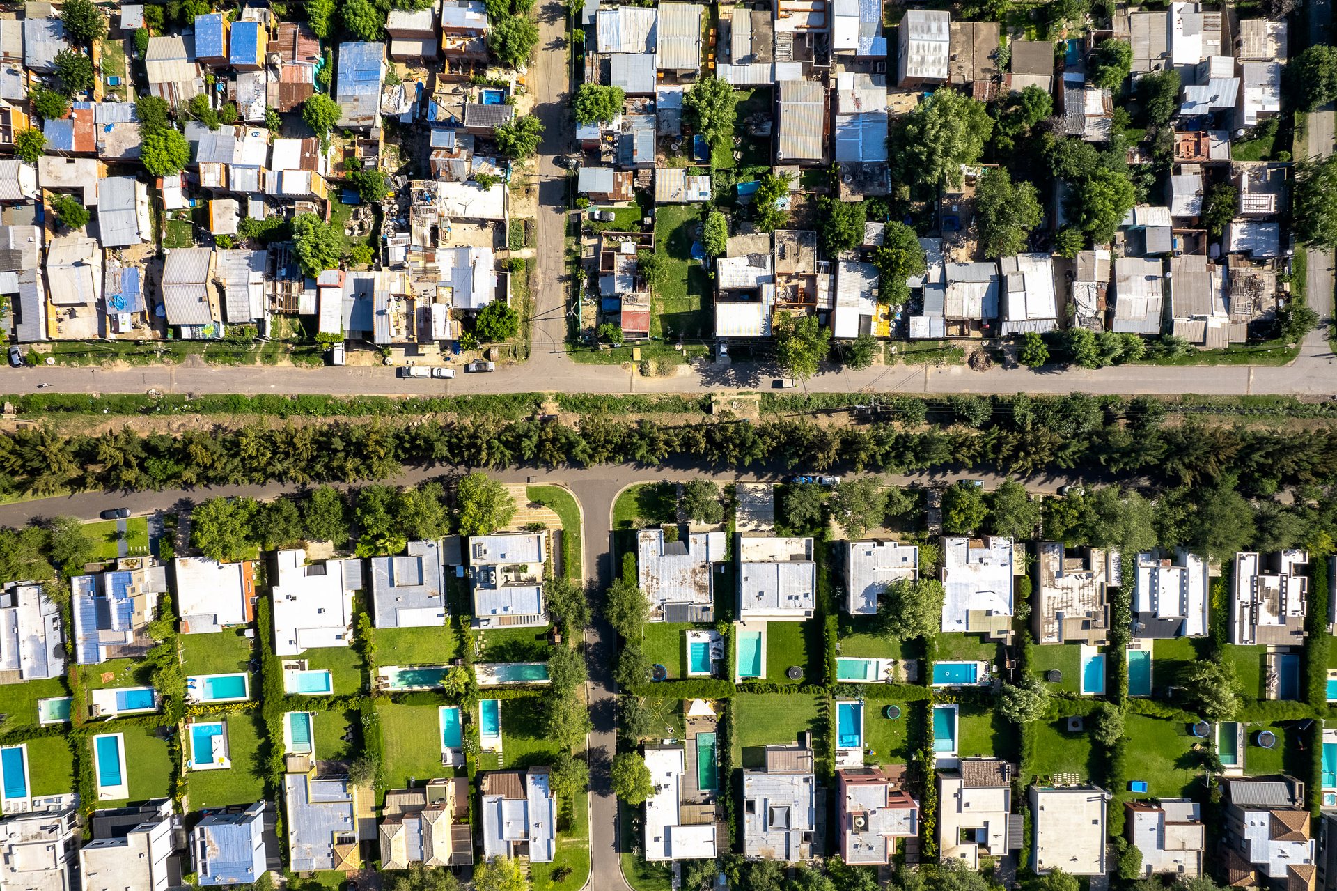 Swimming pools and fences delineate the suburbs into rich and poor in BA province, north of the city.