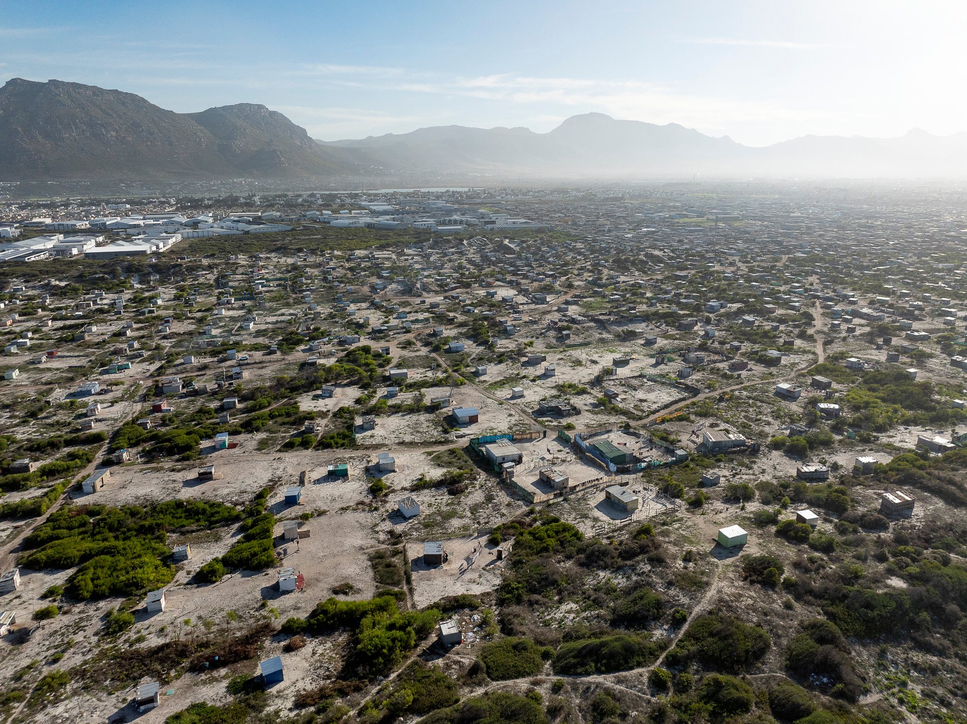 Shacks near Muizenberg, with the rich winelands of Constantia and Tokai in the background.