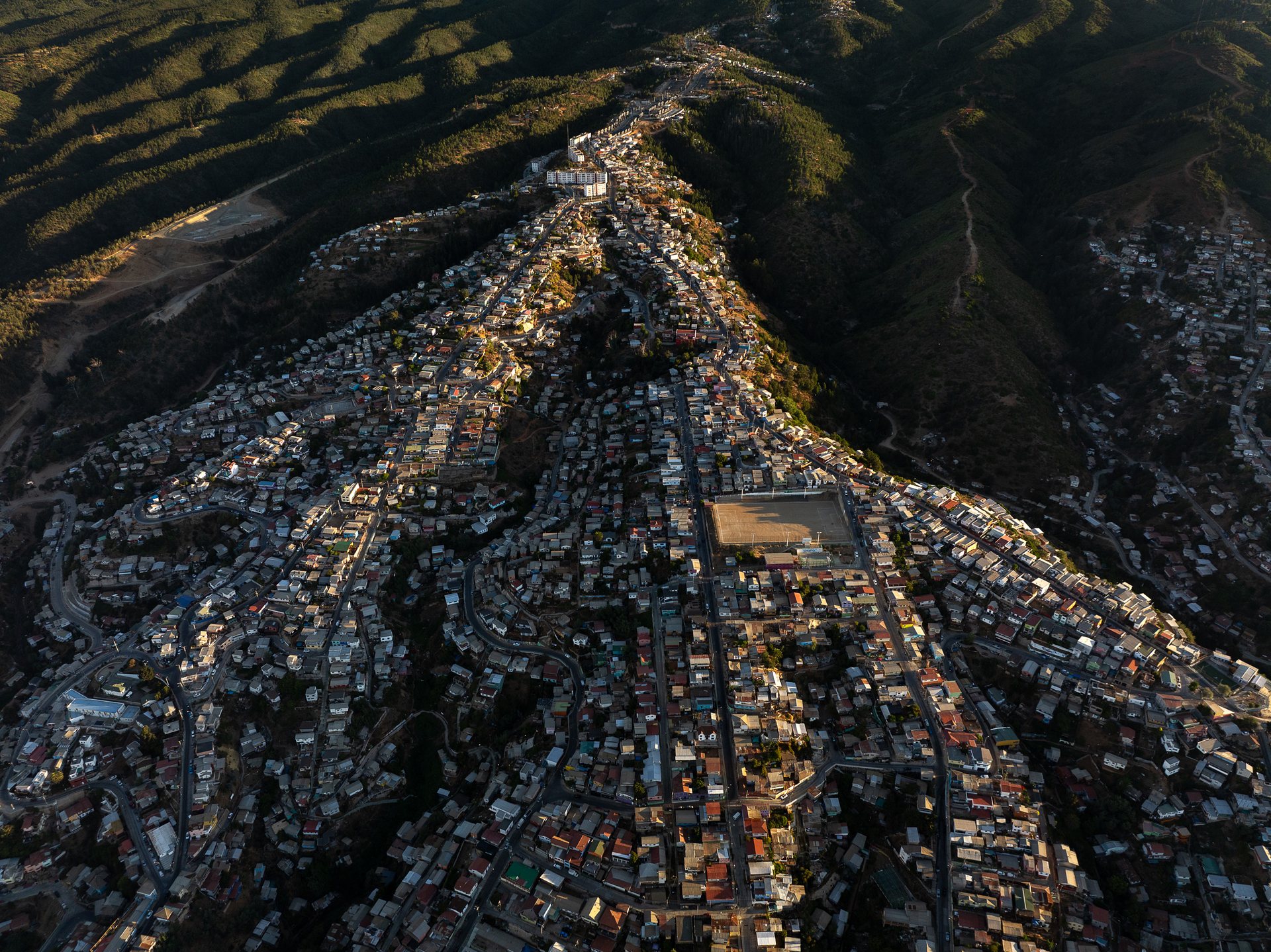 Dense neighborhoods pour down the hills of Valparaiso, Chile.