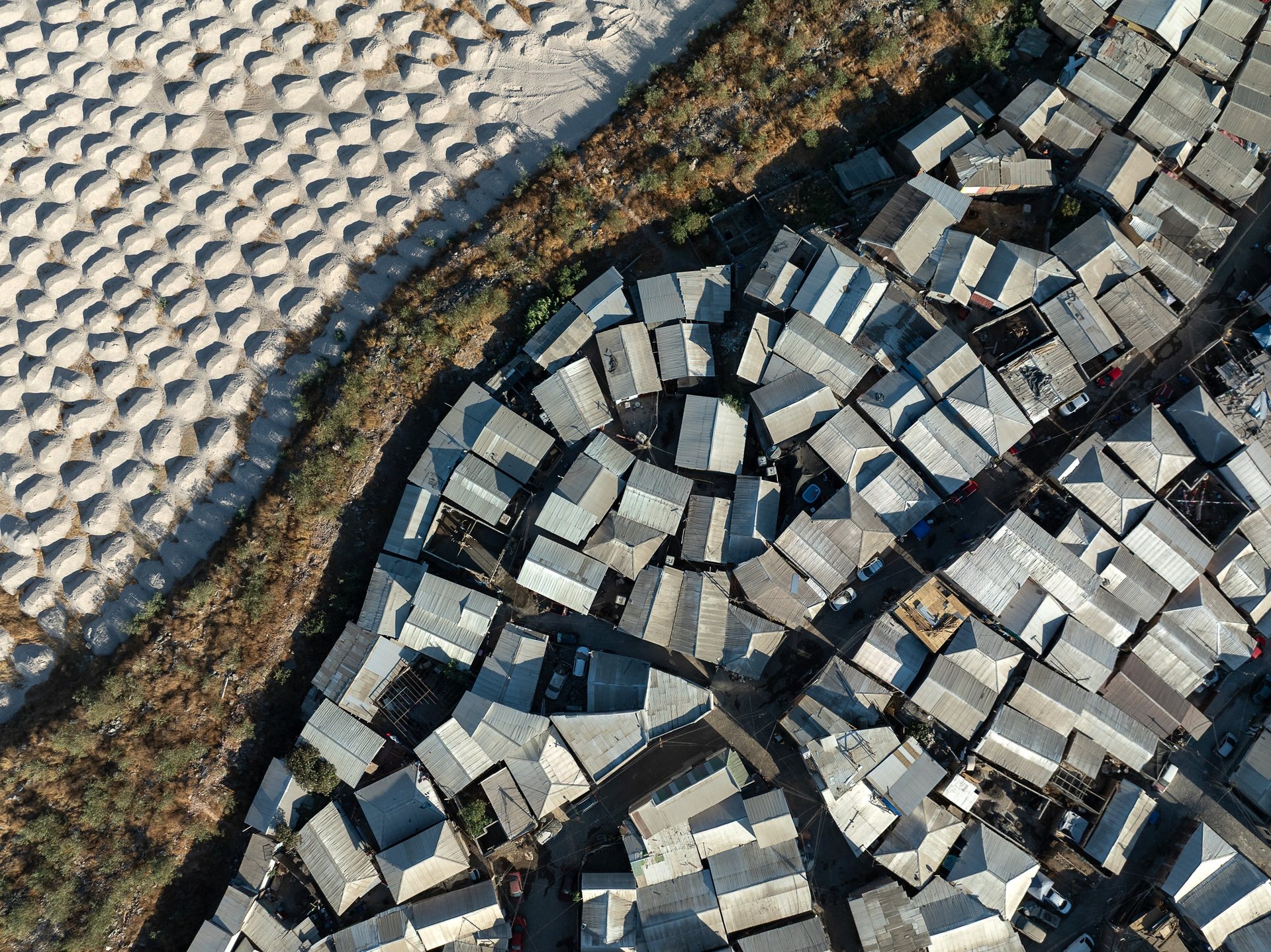 Across Santiago, the state's response to informal settlements is to build: nearly every campamento I flew over had blocks of subsidized