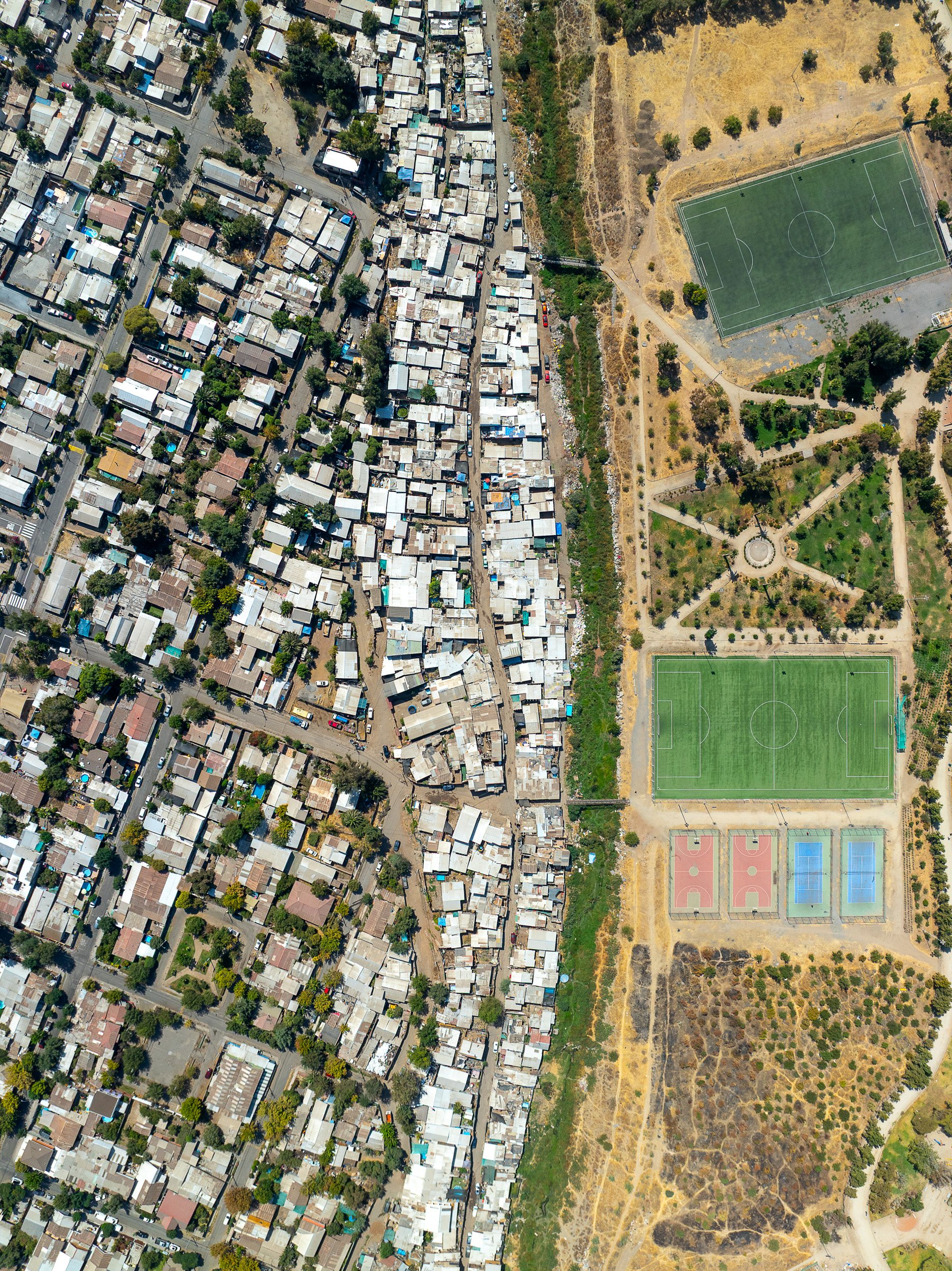 This informal settlement in Santiago is in the process of being formalized as all seem to be, with soccer fields, tennis courts and