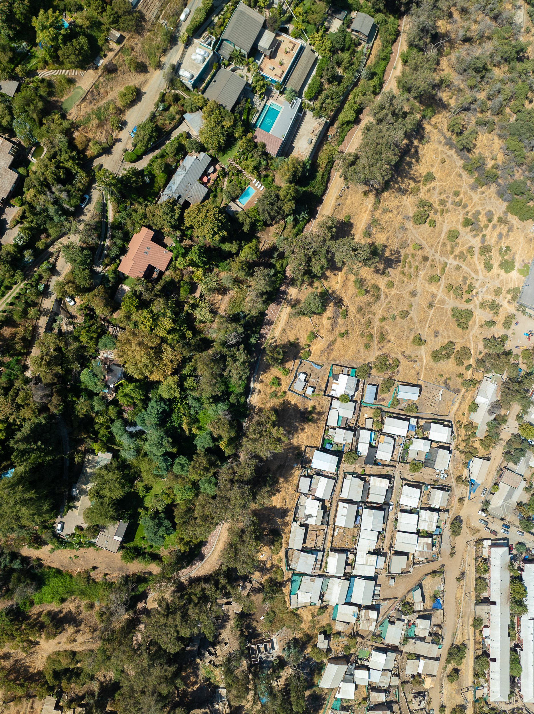 Nice houses in the hills overlook poor homes in the Huecheraba area of Santiago.