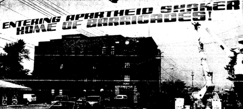 Entering Apartheid Shaker : Photograph of the 1990 banner reading "Entering Apartheid Shaker: Home of Barricades." Put up by Councilman