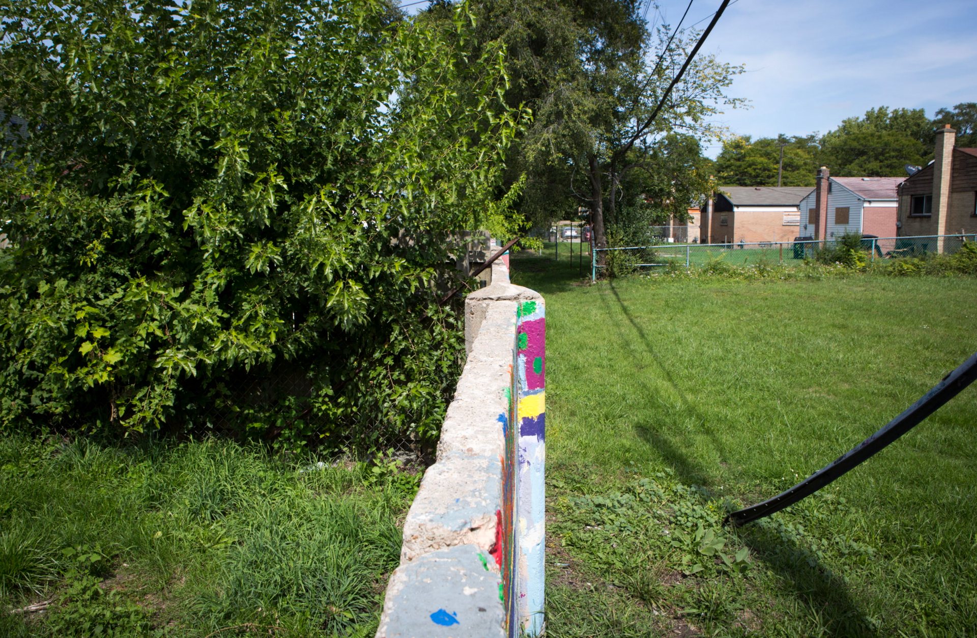 (Above) The Wall, a concrete barrier in 8 Mile, Detroit, built to divide black and white neighborhoods.