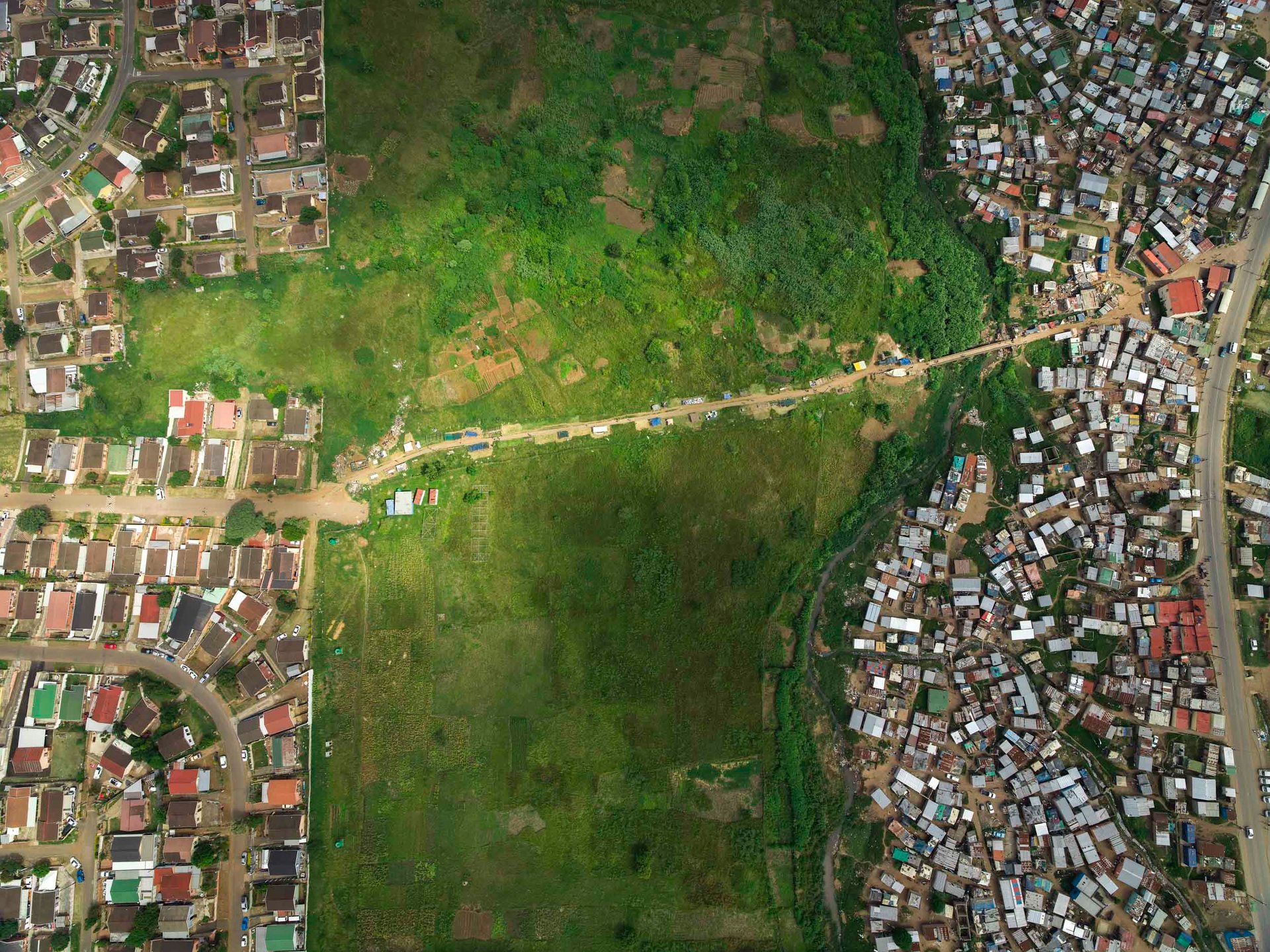 Sunlight shines on the single footpath connecting the Black and Indian communities on either side of the Ohlanga River in Durban, South