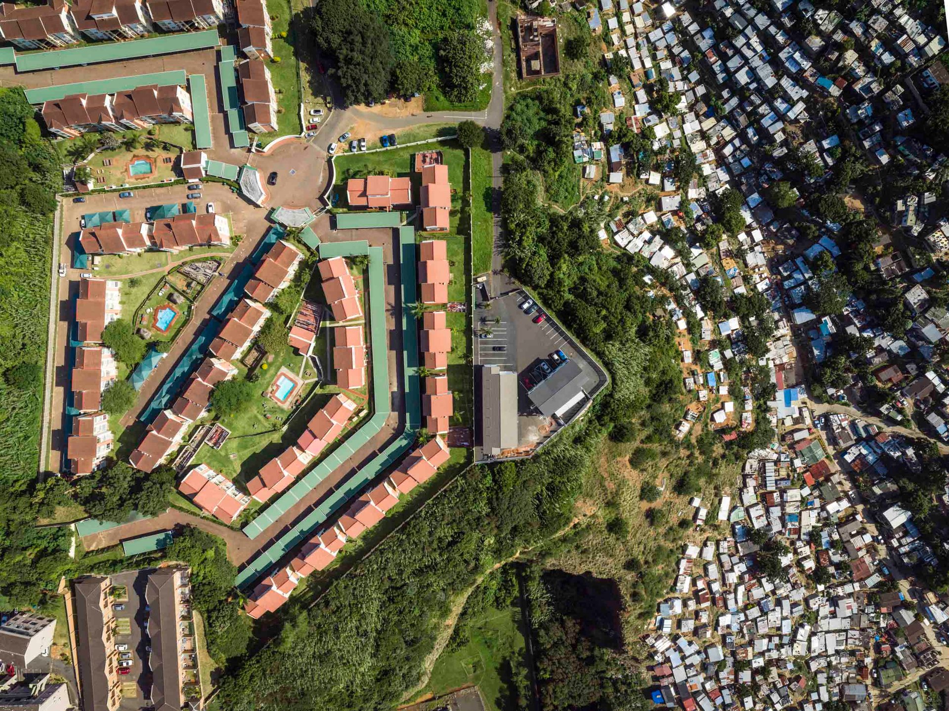 Shacks line the drainages underneath the wealthy suburb of Morningside in Durban, South Africa.