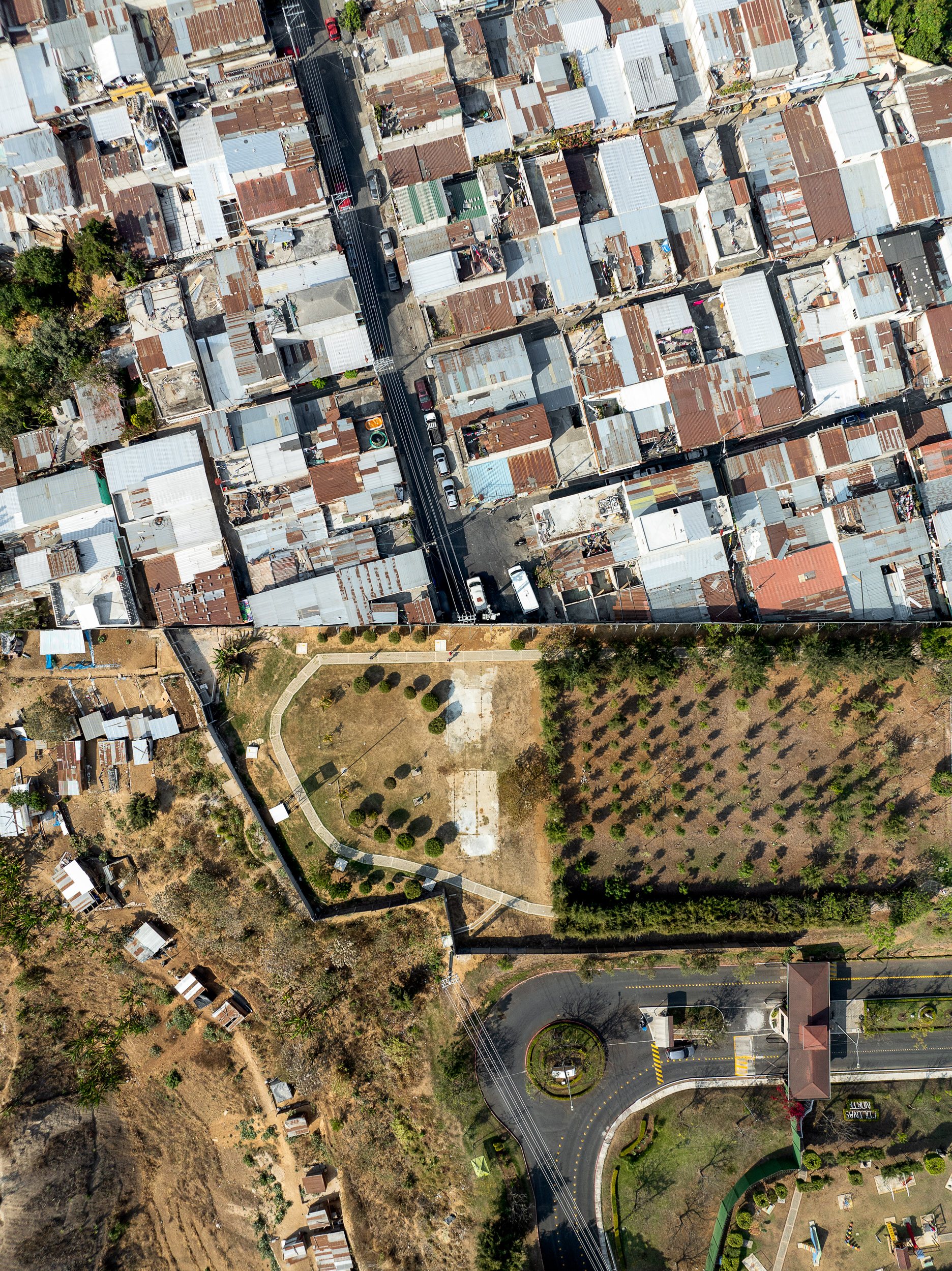 The straight line of a fence which separates the poor from the rich in Mixco.