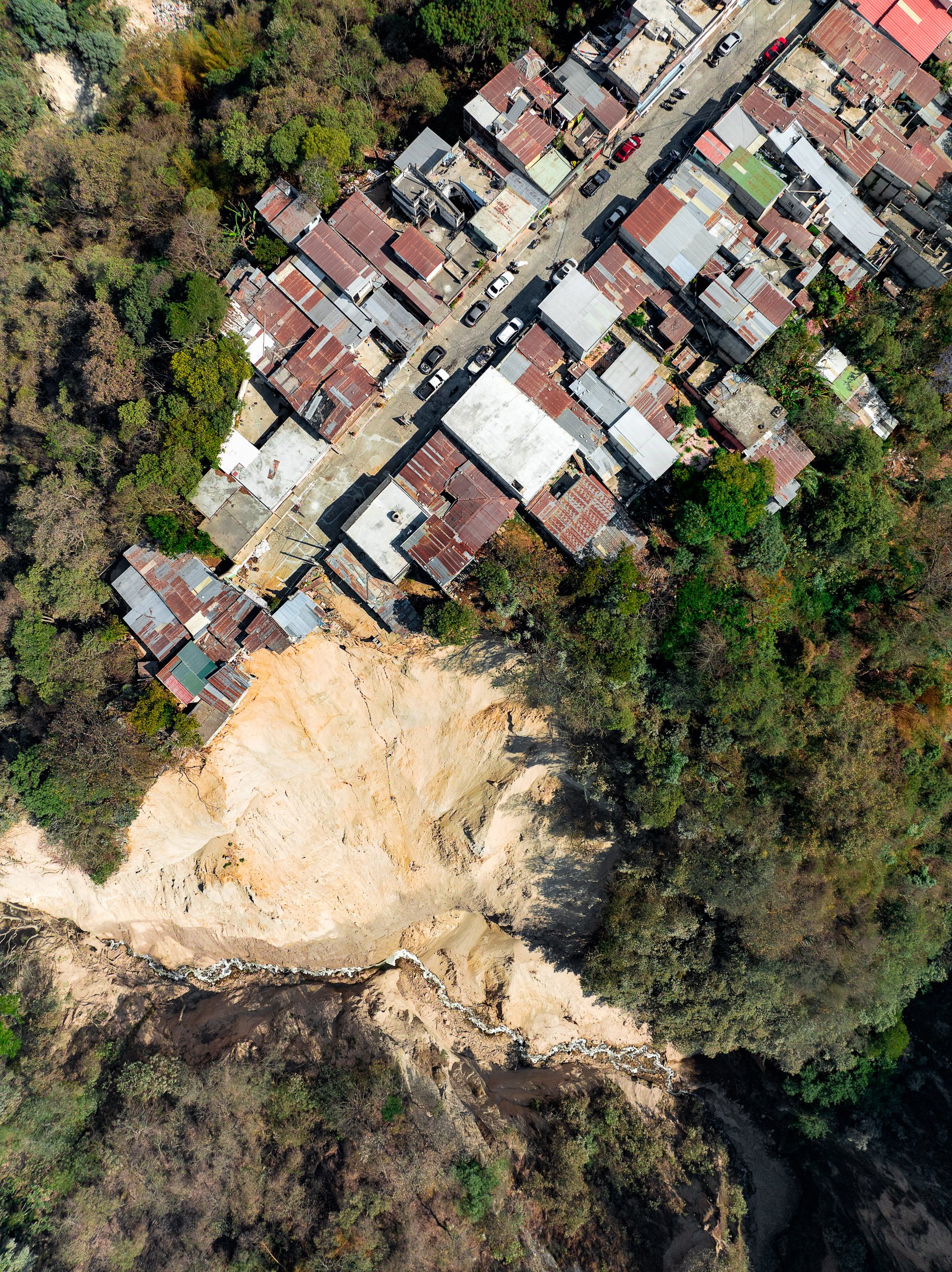 This landslide must have been fairly recent, as the homes still clung to the edge.