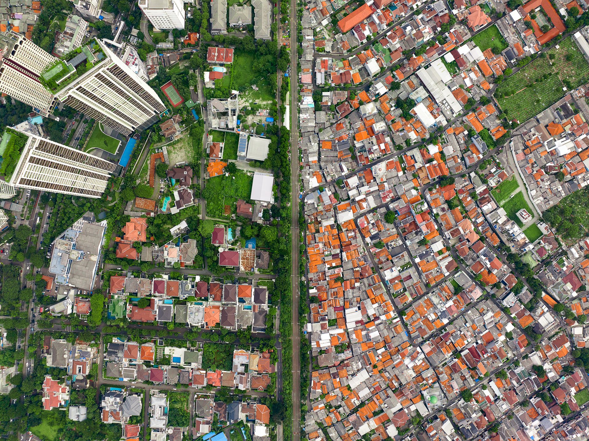 The city's wealthy residents have access to trees, even on the rooftops, providing cover from the relentless heat and smog of the city.