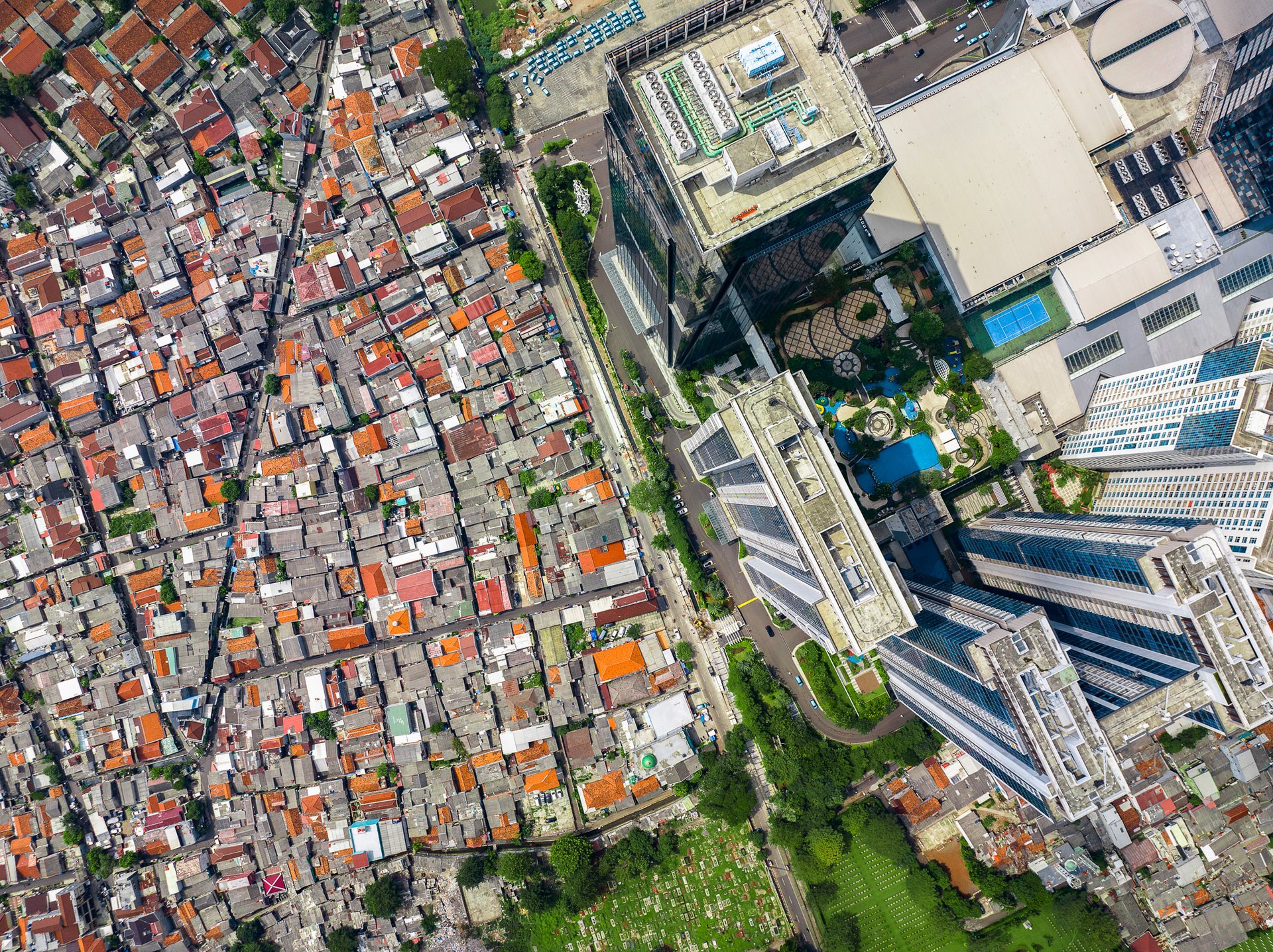 Kampungs next to modern skyscrapers in East Jakarta.