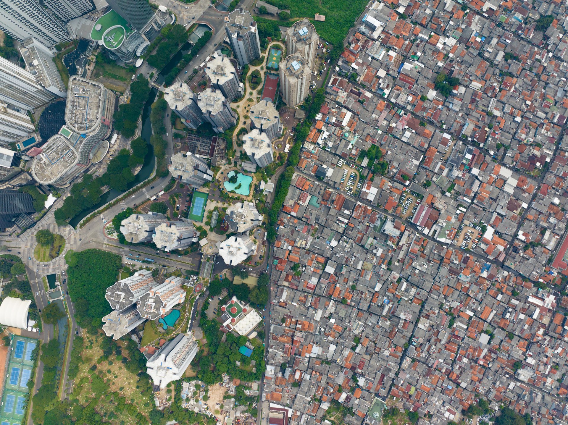 Apartment blocks rise beside the kampungs of East Jakarta.
