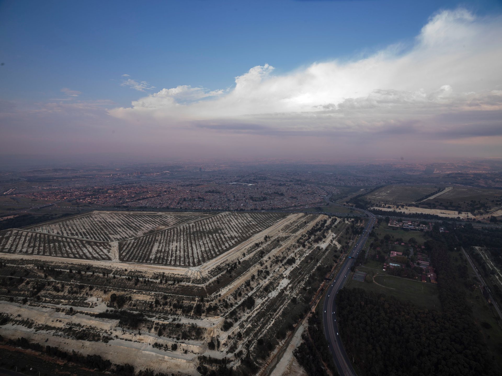 Johannesburg's gold mines, once symbols of wealth, now exacerbate inequality through environmental damage.