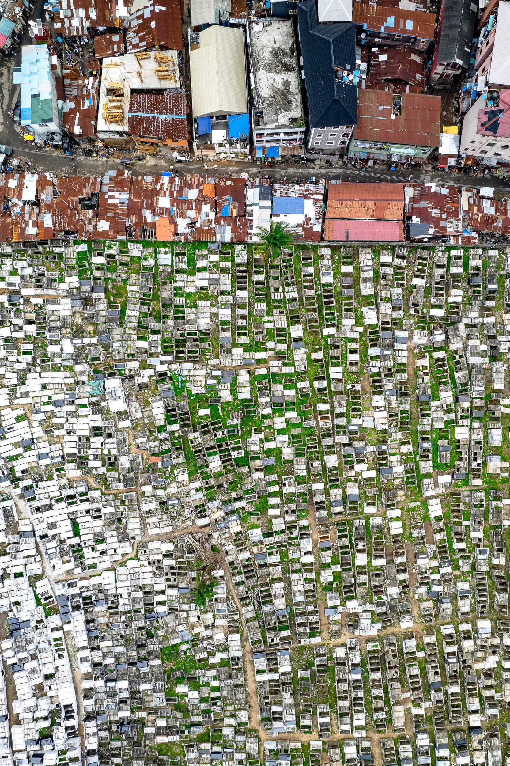 The Abari Cemetery in the middle of Lagos is packed with rows of concrete coffins, many of them decaying and without tops.
