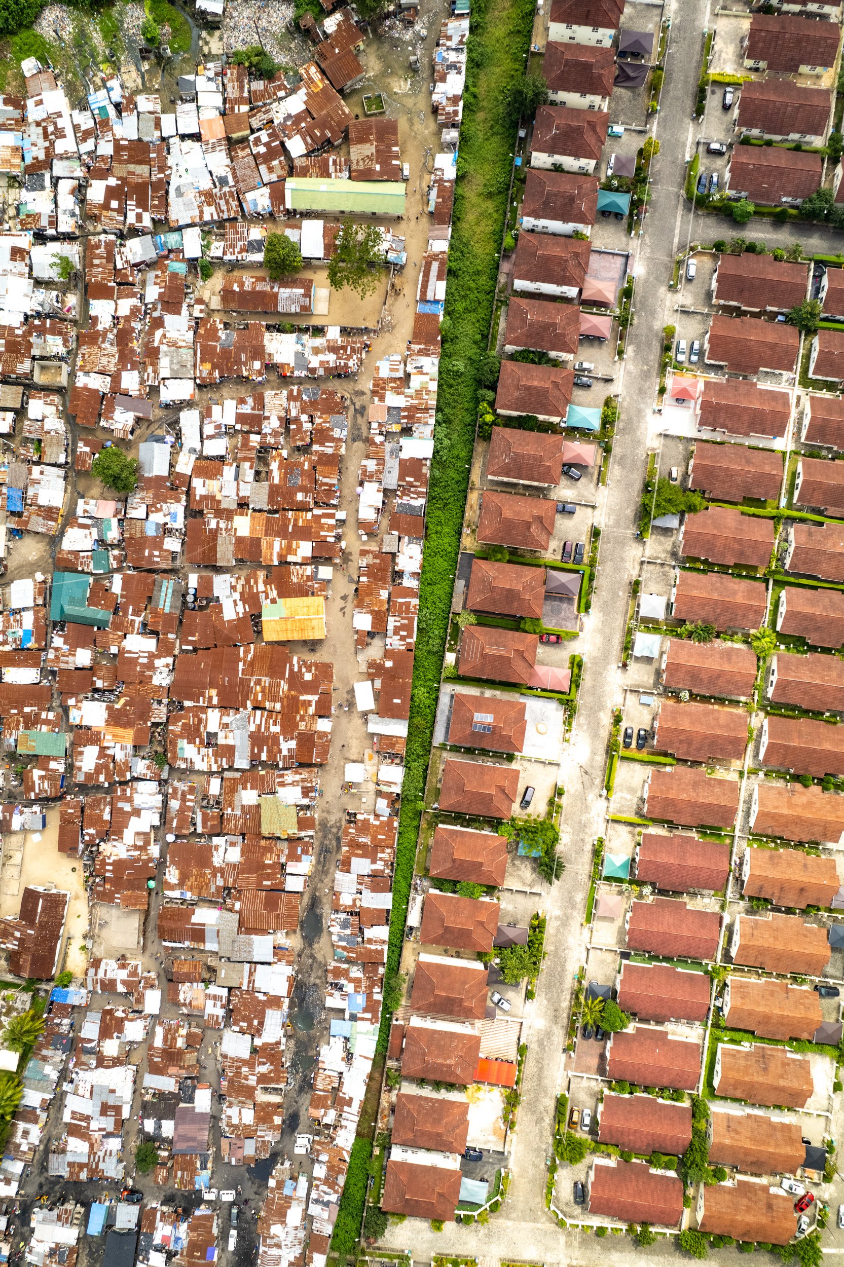 Middle class developments in the upscale Lekki neighborhood abut informal housing.