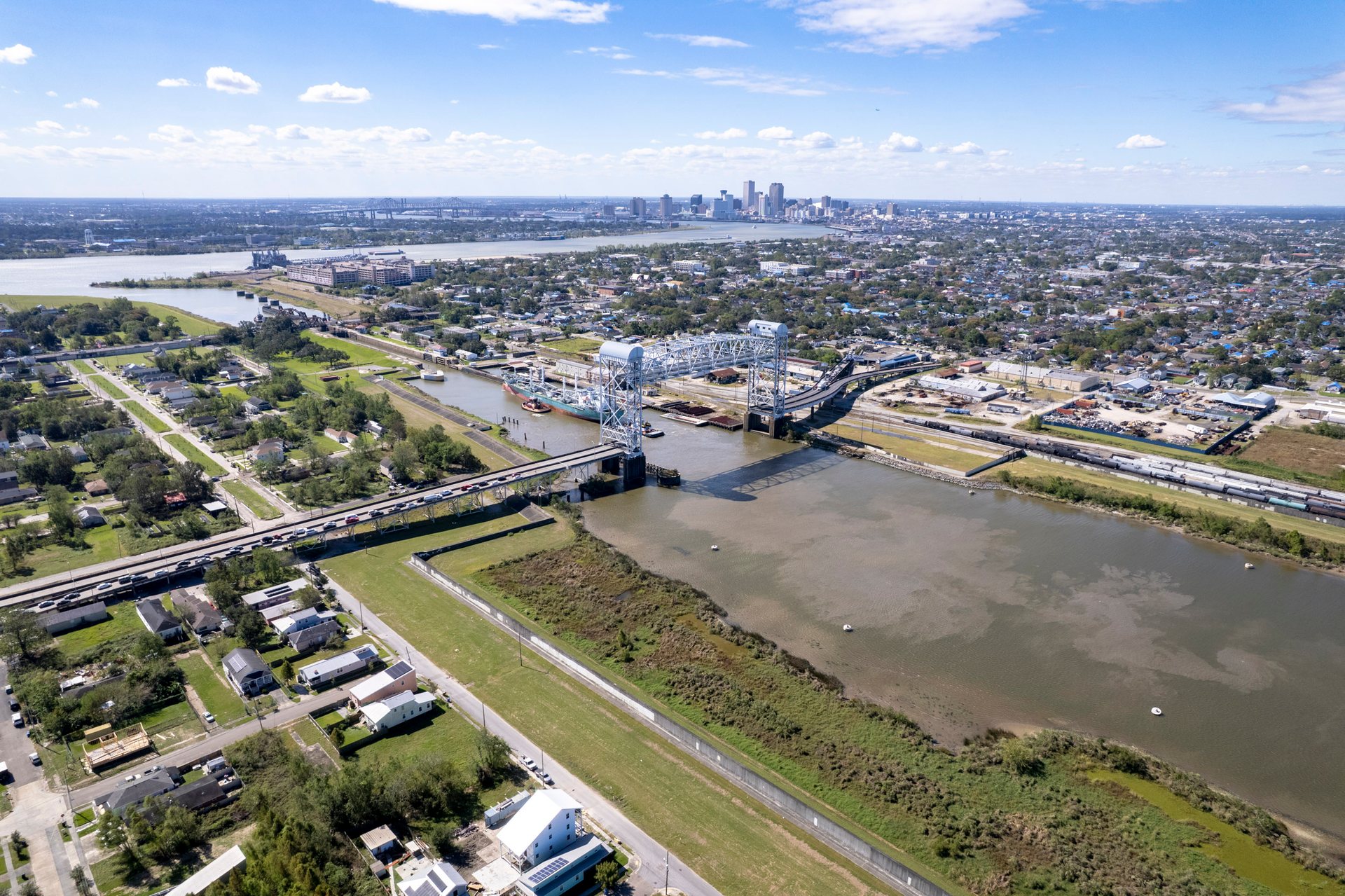 Looking across the bridge toward downtown, the Lower Ninth Ward shows both ruin and renewal.