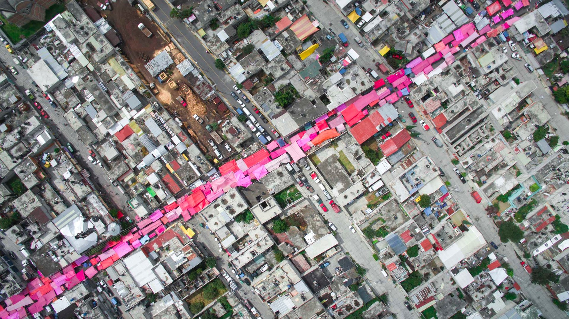 On certain days in Mexico City there will be a brushstroke of pink or yellow seen from above - the informal markets called tianguis .