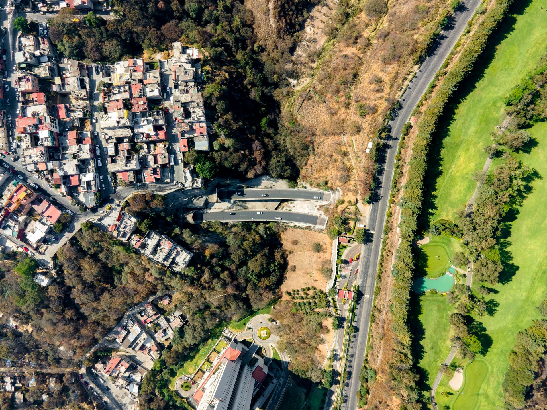 Innovative traffic solutions for the hilly environment have highways running underneath entire communities, rich and poor.