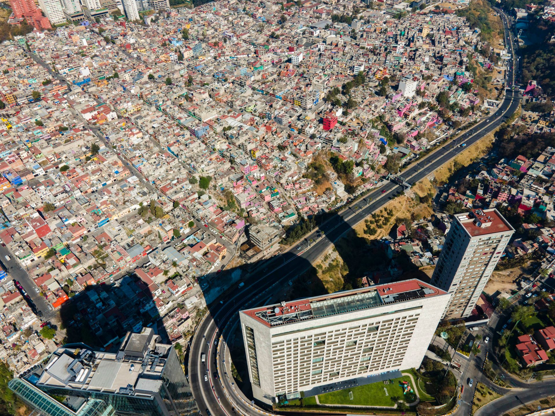A gated housing estate in the Ixtapalapa neighborhood sits next to a classic concrete low-income area.