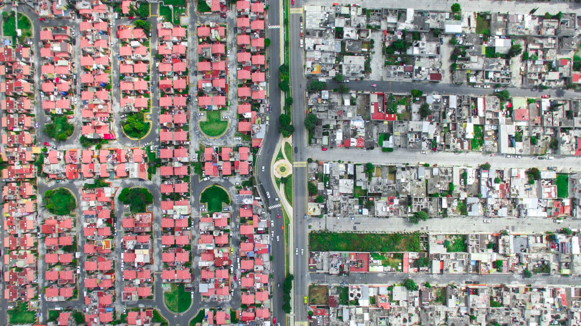 A gated housing estate in the Ixtapalapa neighborhood sits next to a classic concrete low-income area.
