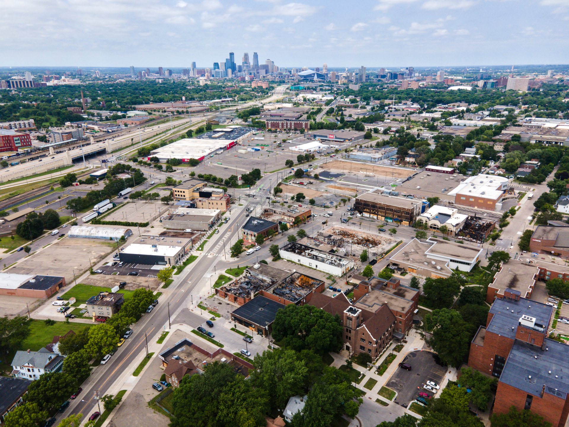 Businesses lay in ruins at the intersection of Lake St and Minnehaha Ave, where the abandoned 3rd police precinct still stands.