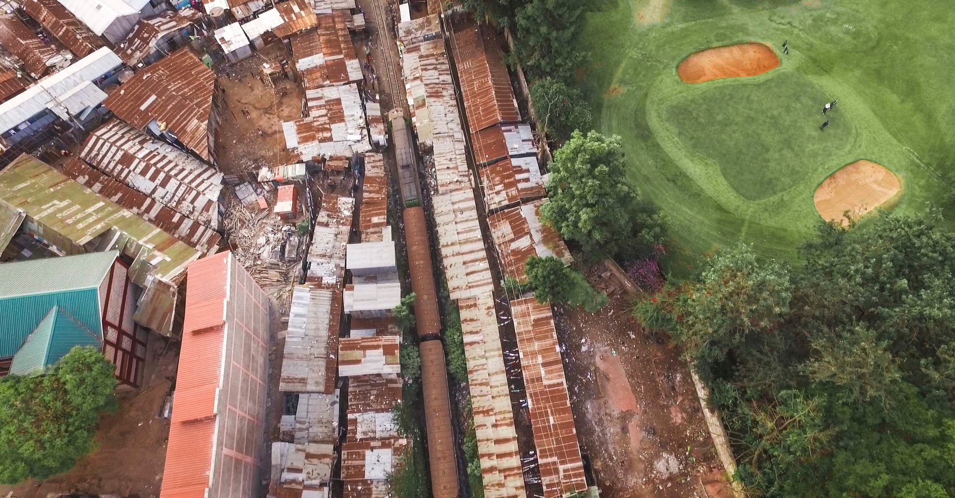 Aerial photo of Nairobi slum pressing up against the manicured edges of a private golf course.