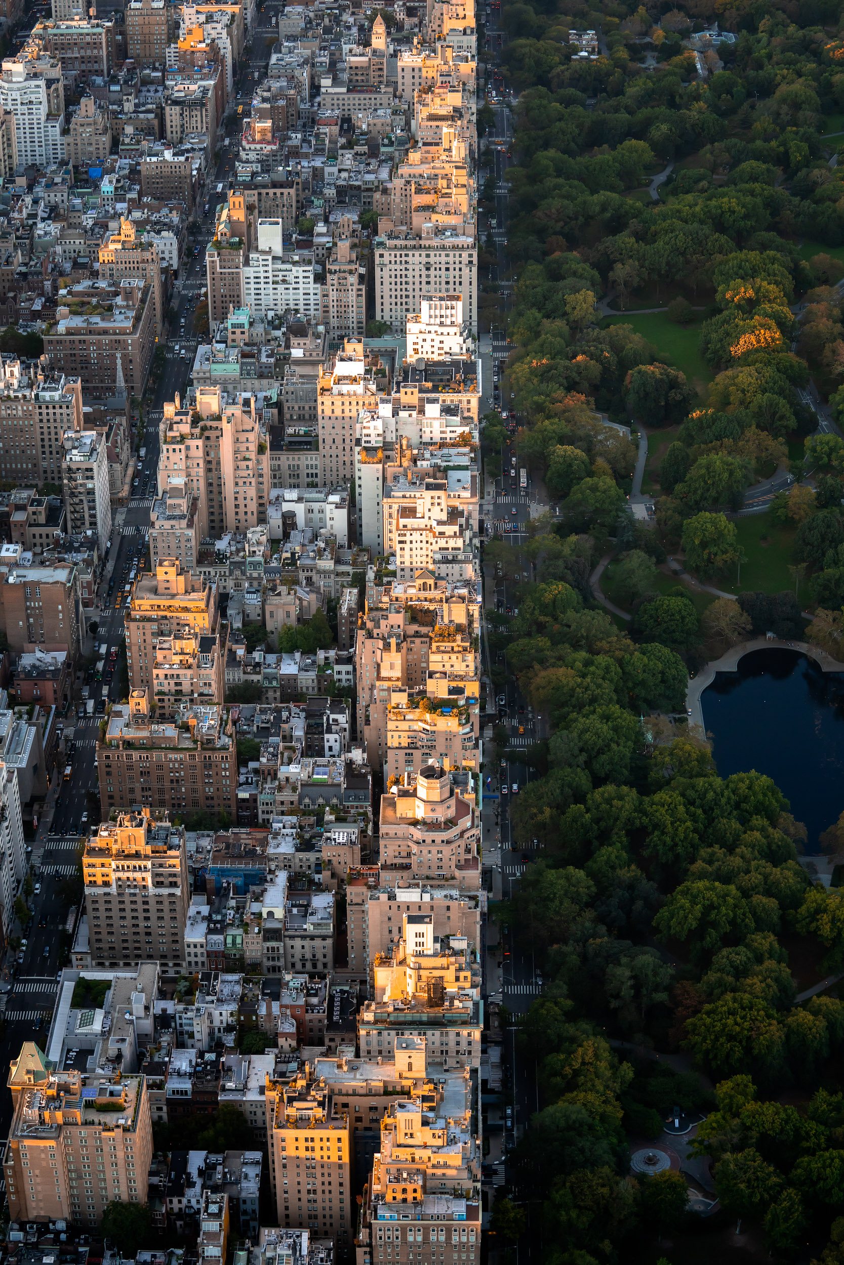 Luxury apartment blocks catch the rising sunlight on Central Park East.