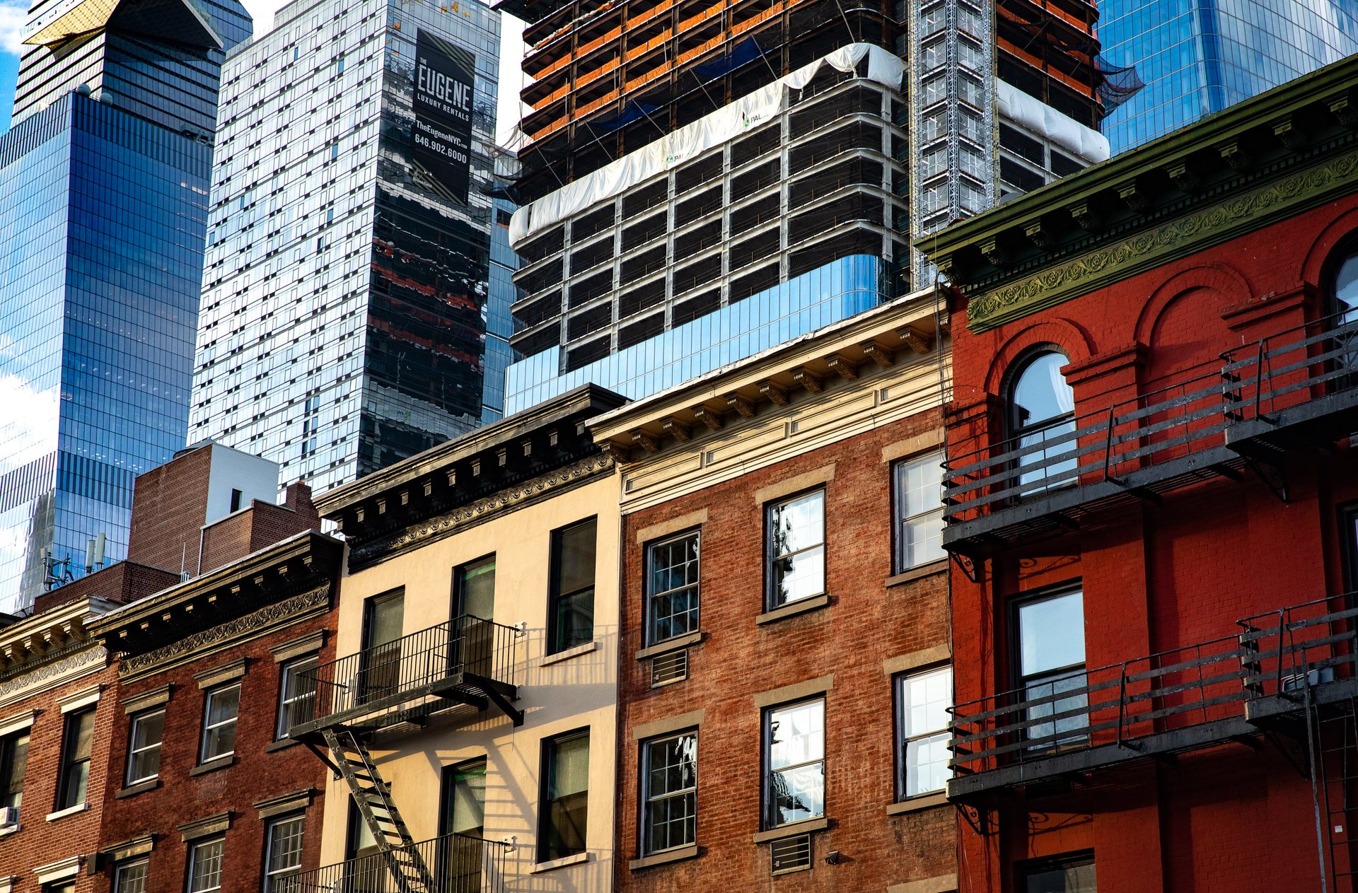 Hudson Yards grows continuously behind historic multi-story Manhattan architecture along the city's west side.