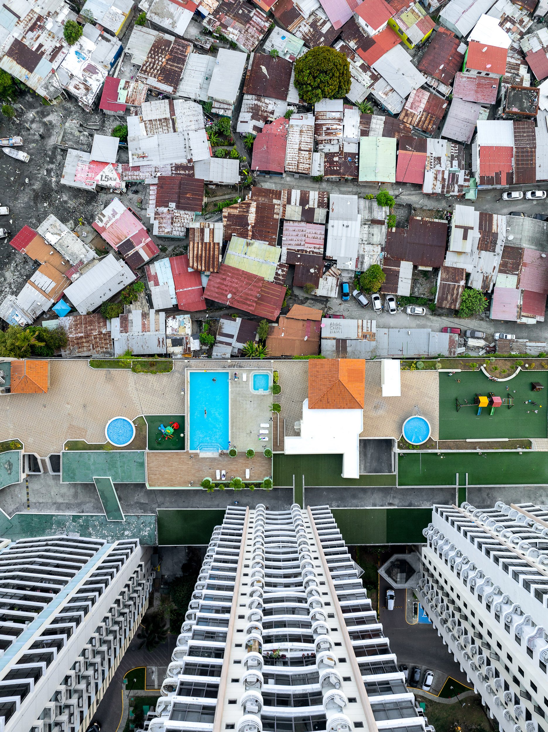 The fisherman's neighborhood of Boca La Caja is bounded on two sides by wealthy tower blocks, where families can swim or walk their dogs at the end of the day.