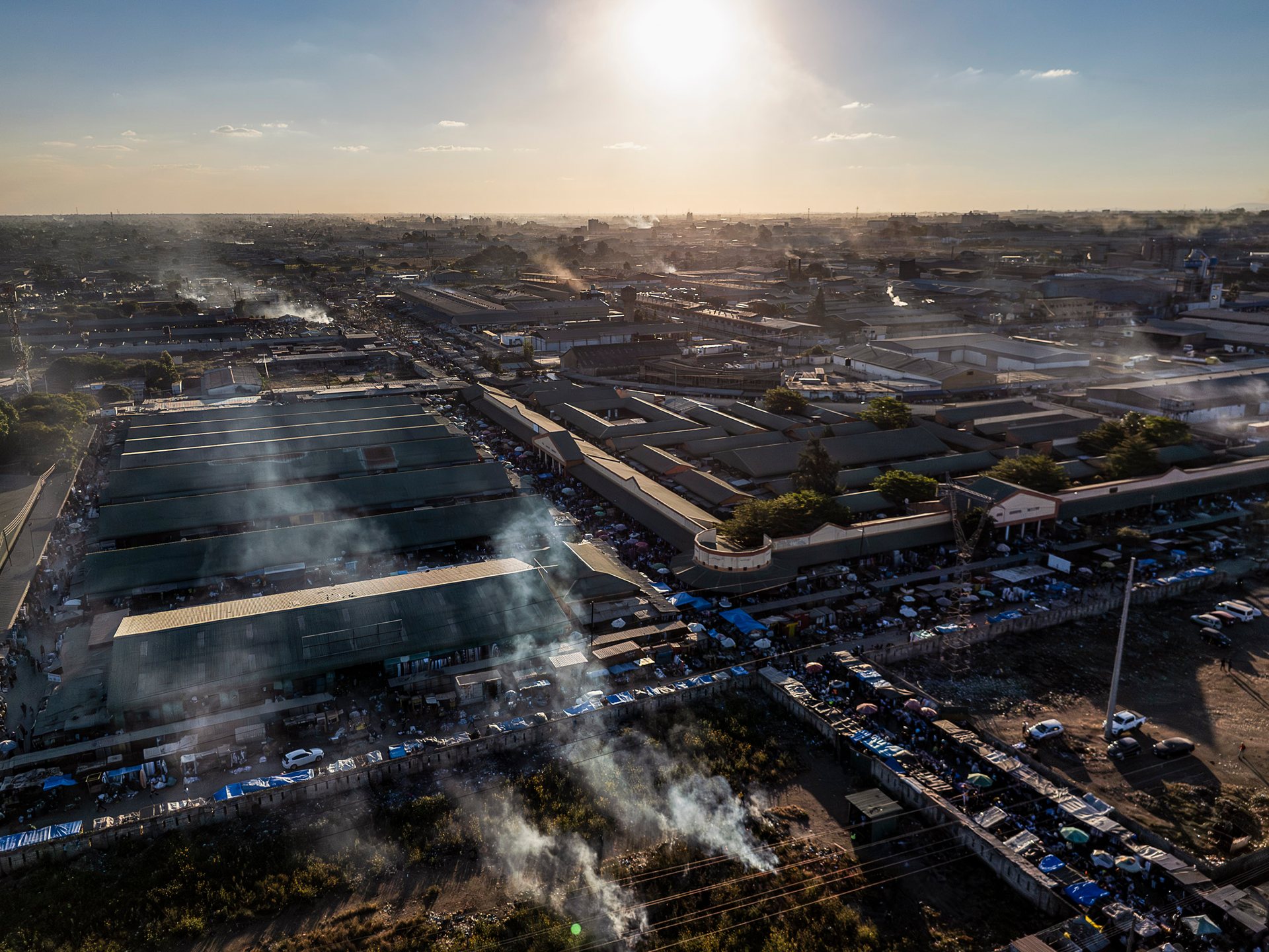 The fringes of Soweto Market, Zambia's largest, where the formal grid of the CBD dissolves into a labyrinth of stalls, tarps, and handcarts.